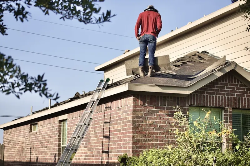 Professional roofer working on a residential roof in Great Oaks
